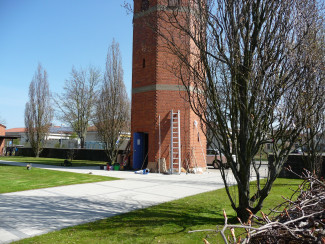 Turm, davor Gartengeräte